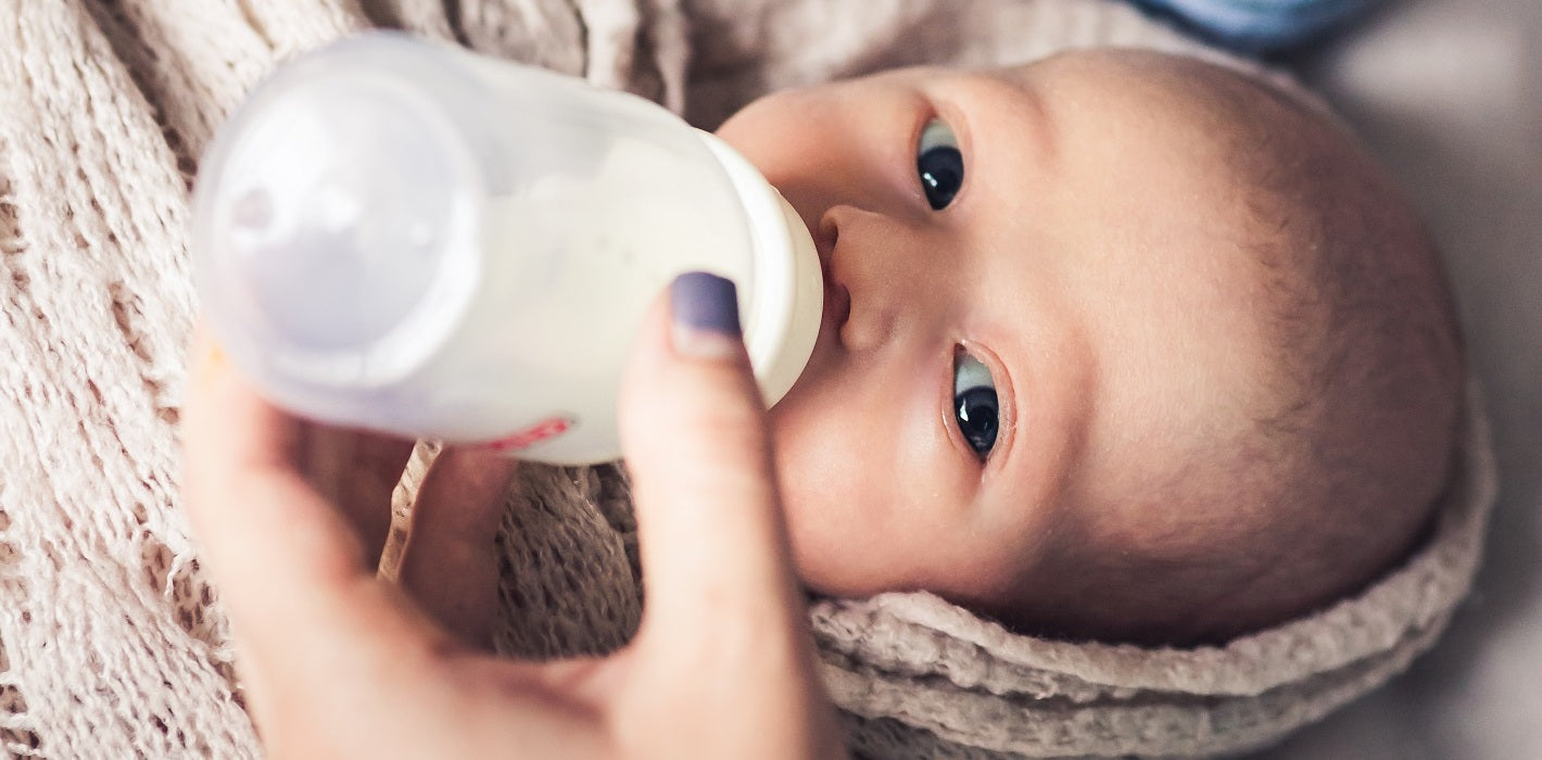 Baby gulping milk from hot sale bottle